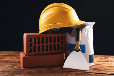 Photo of Different construction material and tools on wooden table