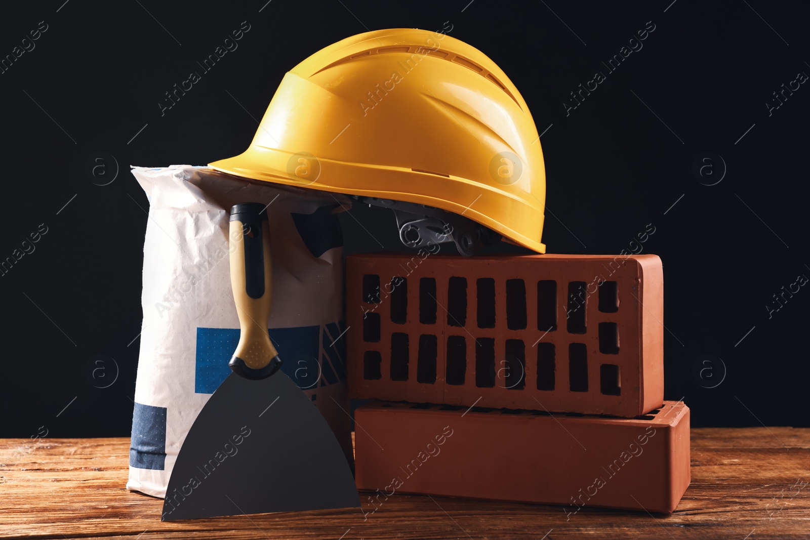 Photo of Different construction material and tools on wooden table