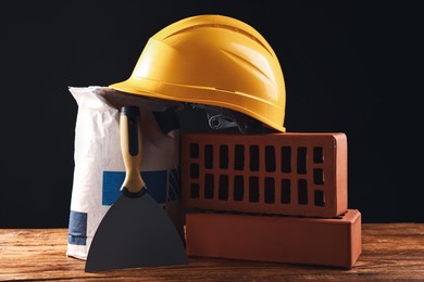 Photo of Different construction material and tools on wooden table