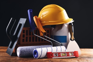 Photo of Different construction material and tools on wooden table