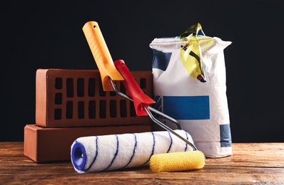 Photo of Different construction material and tools on wooden table