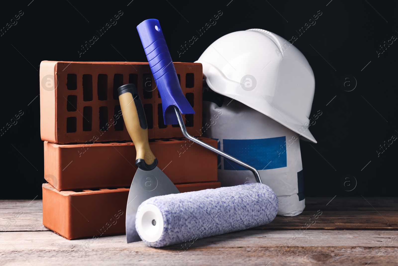 Photo of Different construction material and tools on wooden table