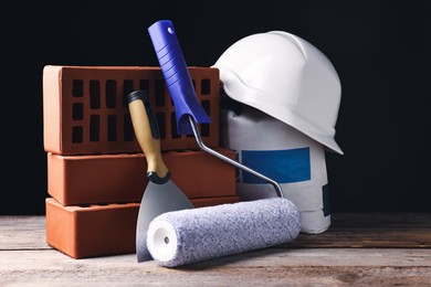 Photo of Different construction material and tools on wooden table