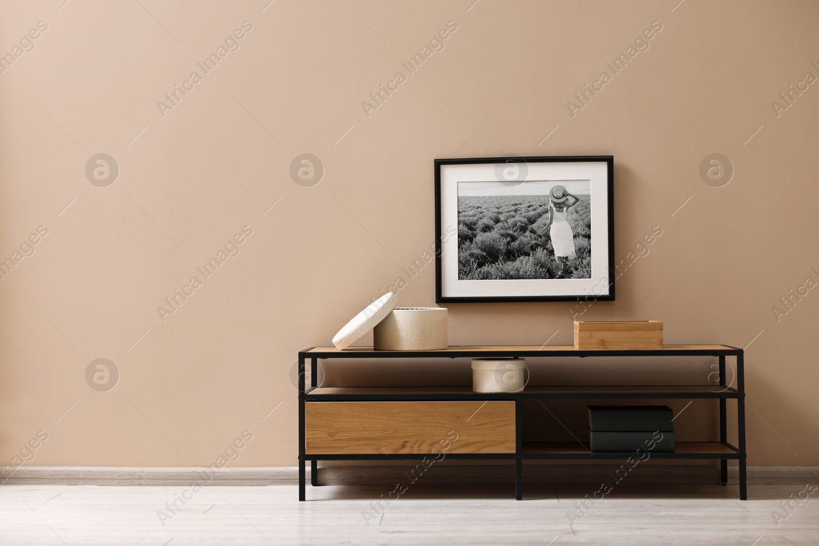 Photo of Console table and decor near dark beige wall in room, space for text. Interior design