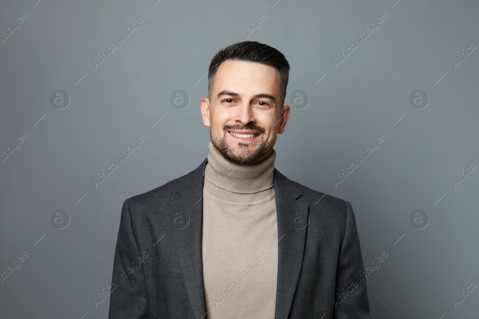 Photo of Portrait of handsome middle aged man on grey background