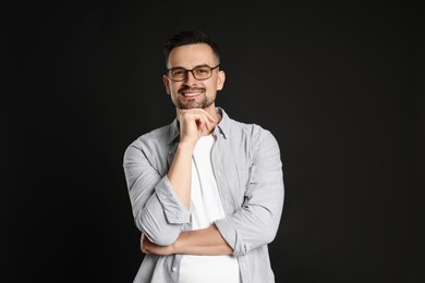 Photo of Portrait of handsome middle aged man on black background