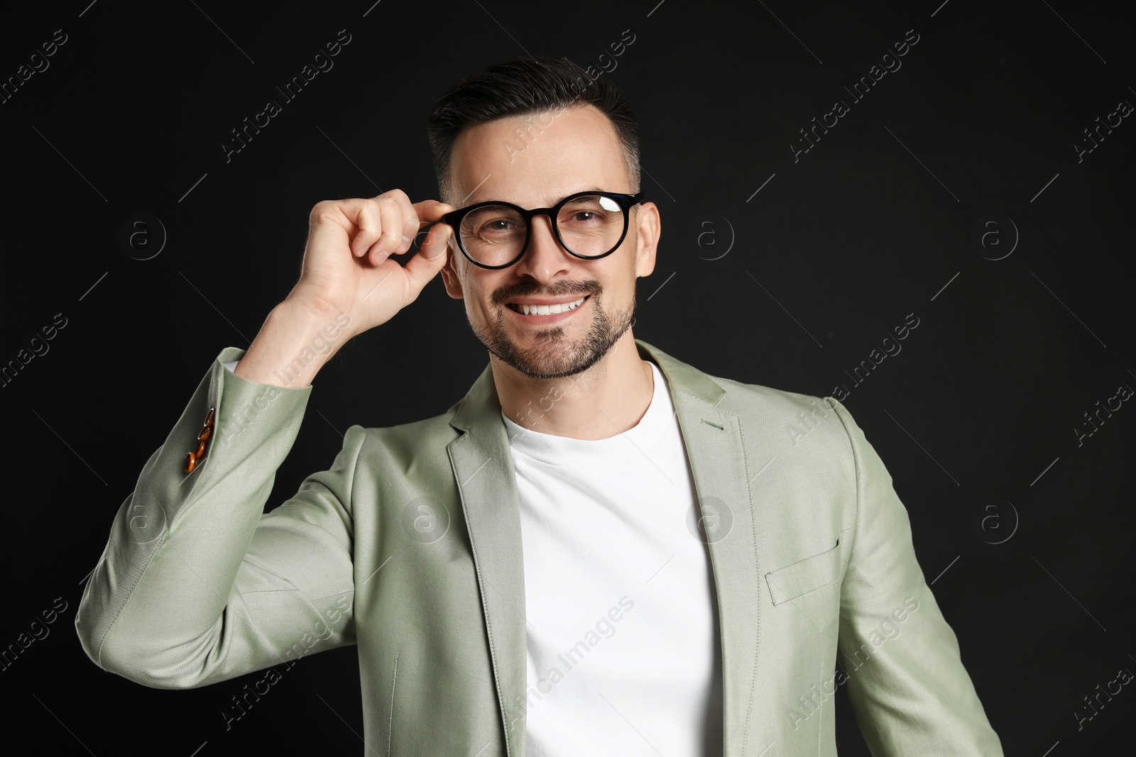 Photo of Portrait of handsome middle aged man on black background