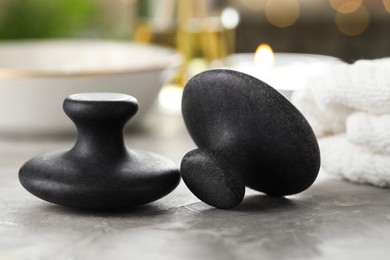 Photo of Massage stones on grey background, closeup. Spa treatment