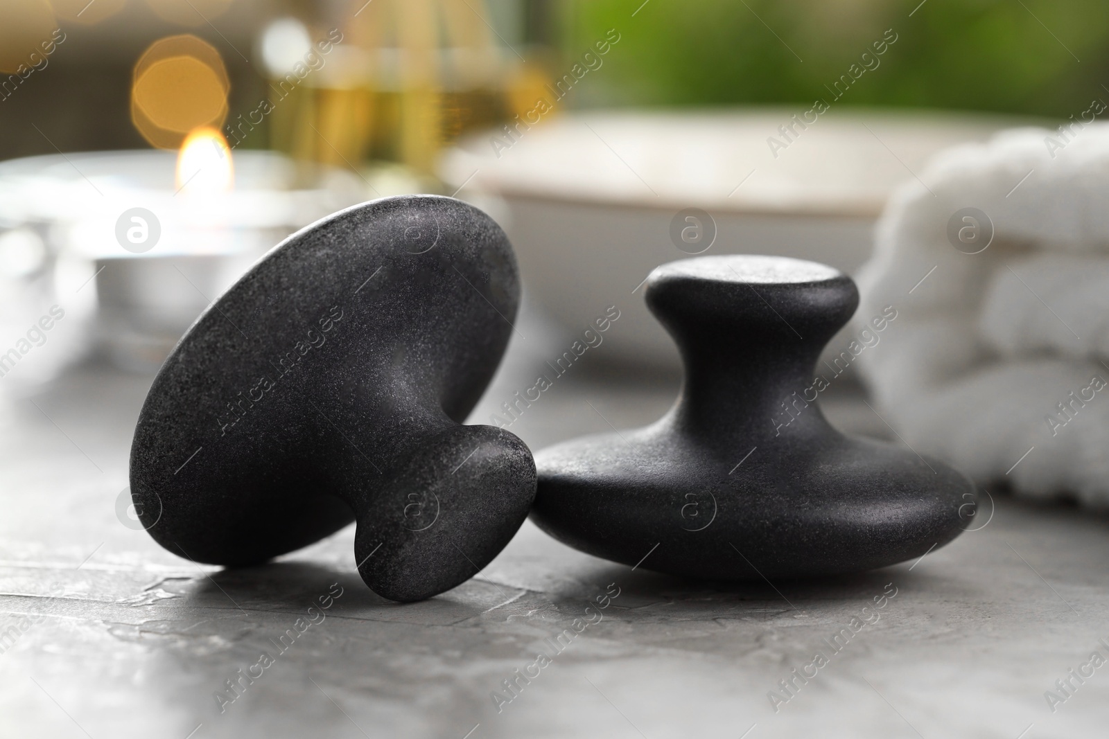 Photo of Massage stones on grey background, closeup. Spa treatment