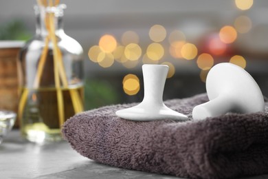 Photo of Spa stones and towel on grey table, closeup