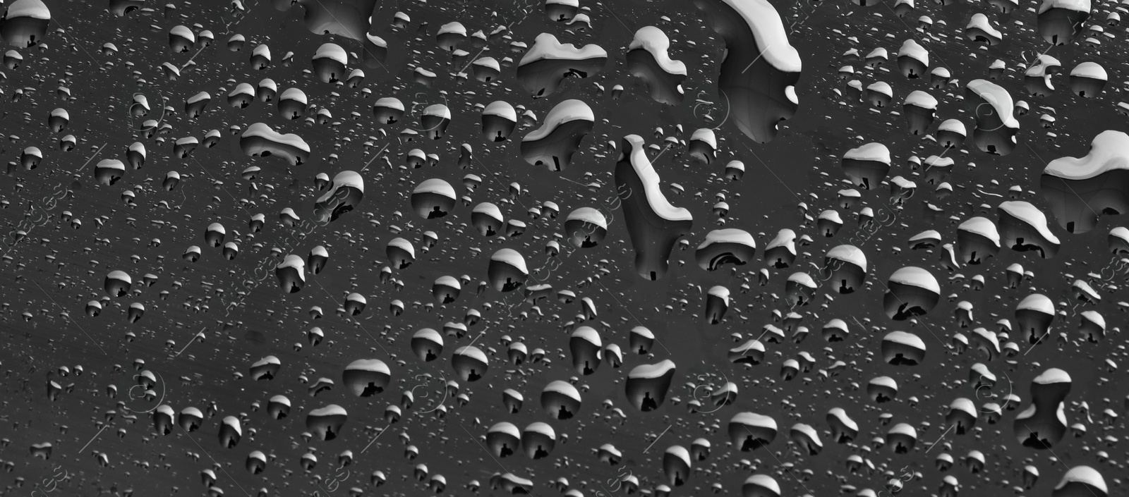 Photo of Water drops on grey glass surface, top view