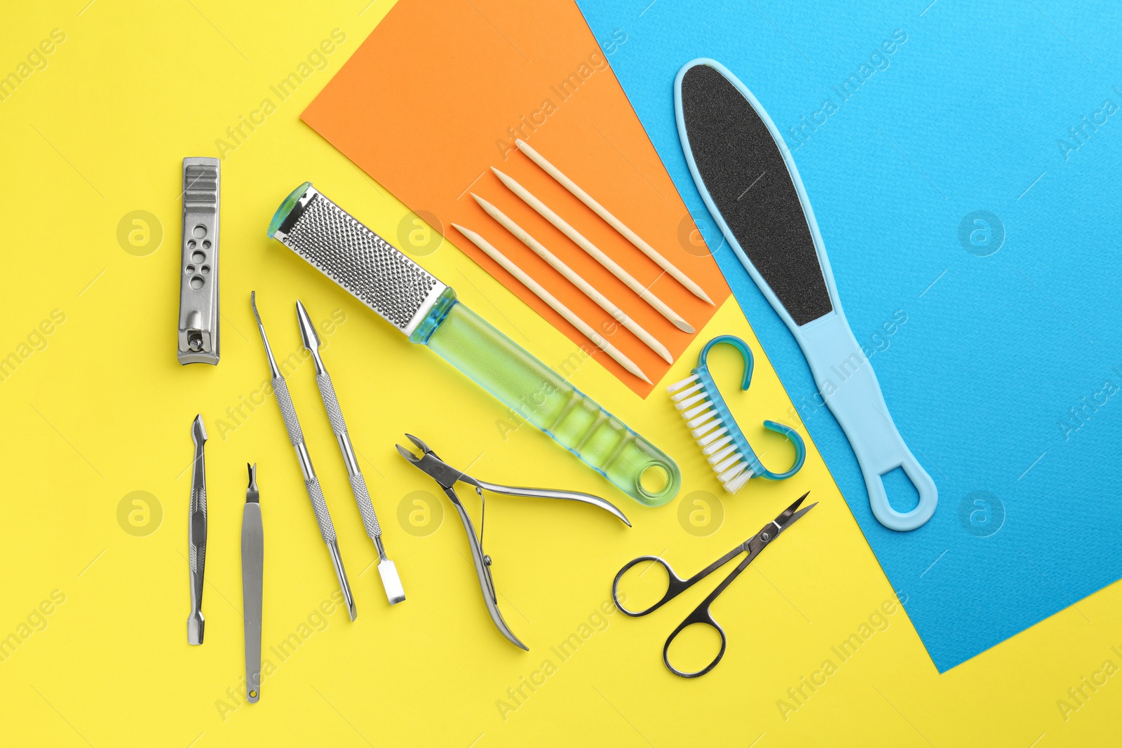 Photo of Set of pedicure tools on color background, flat lay