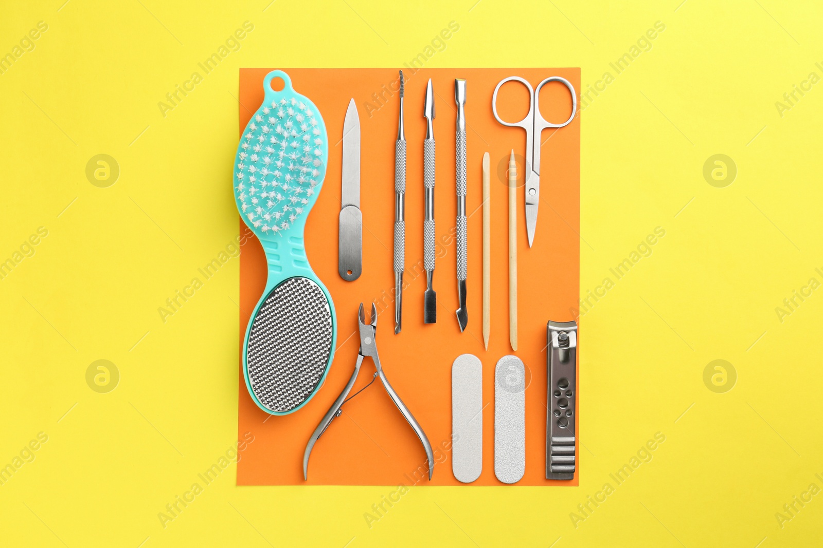 Photo of Set of pedicure tools on color background, flat lay