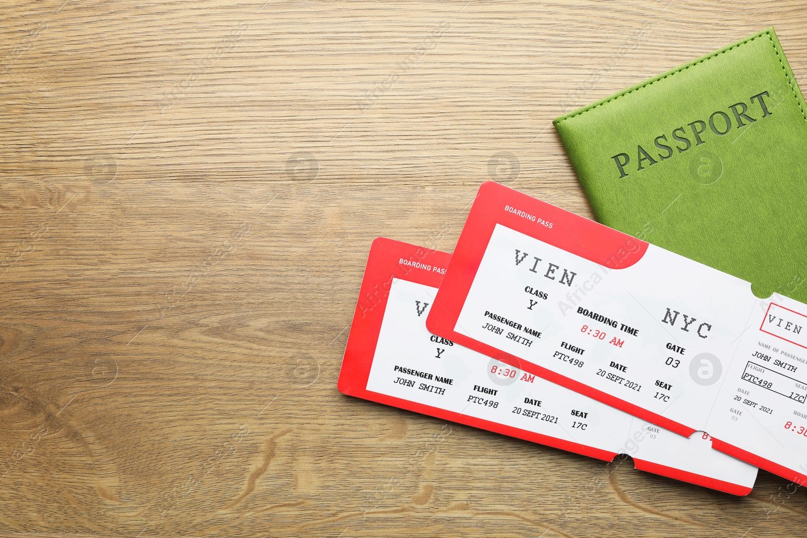 Photo of Travel agency. Flight tickets and passport on wooden table, flat lay. Space for text