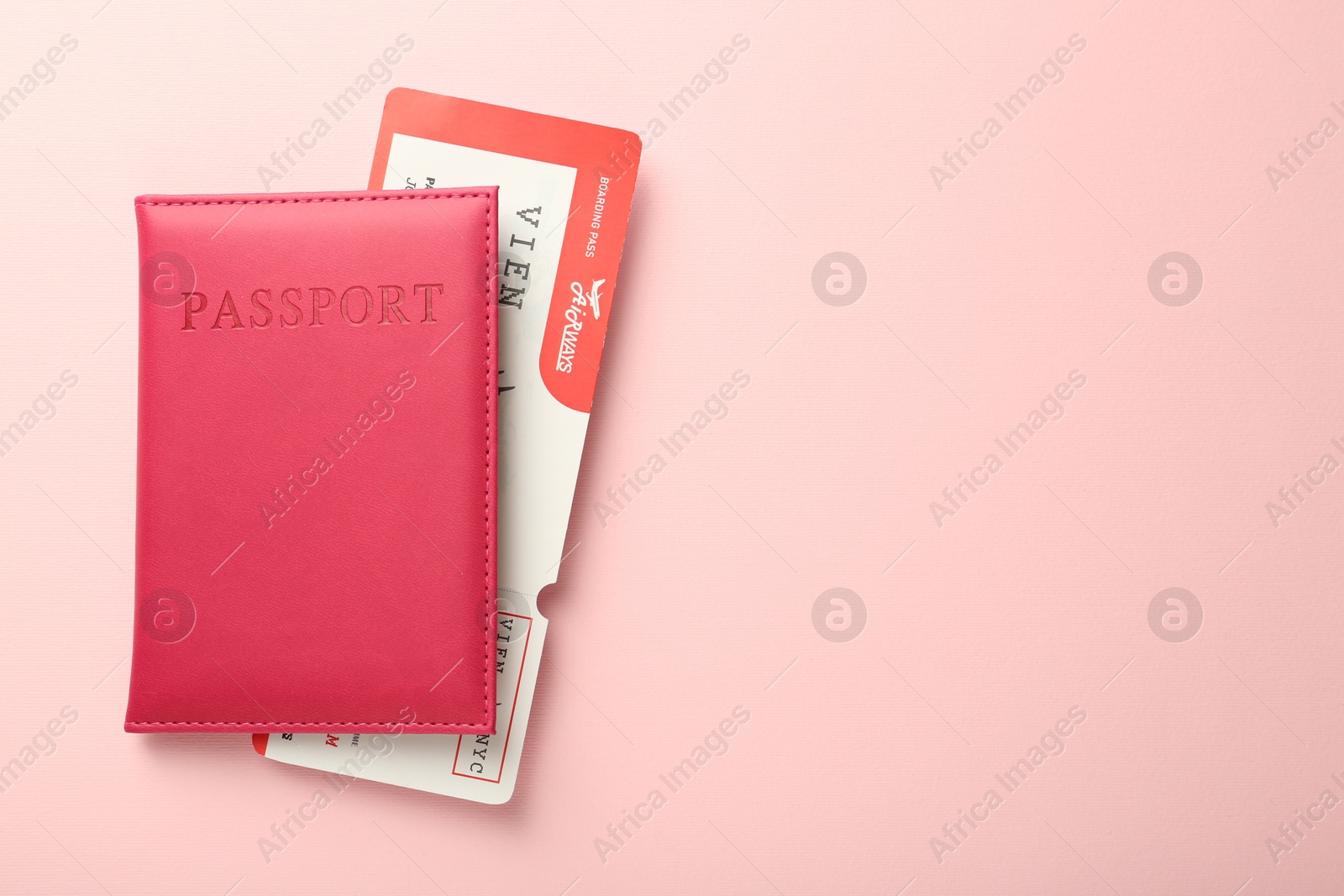 Photo of Passport with ticket on pink background, top view. Space for text