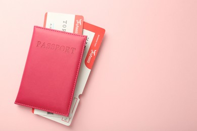 Photo of Passport with tickets on pink background, top view. Space for text