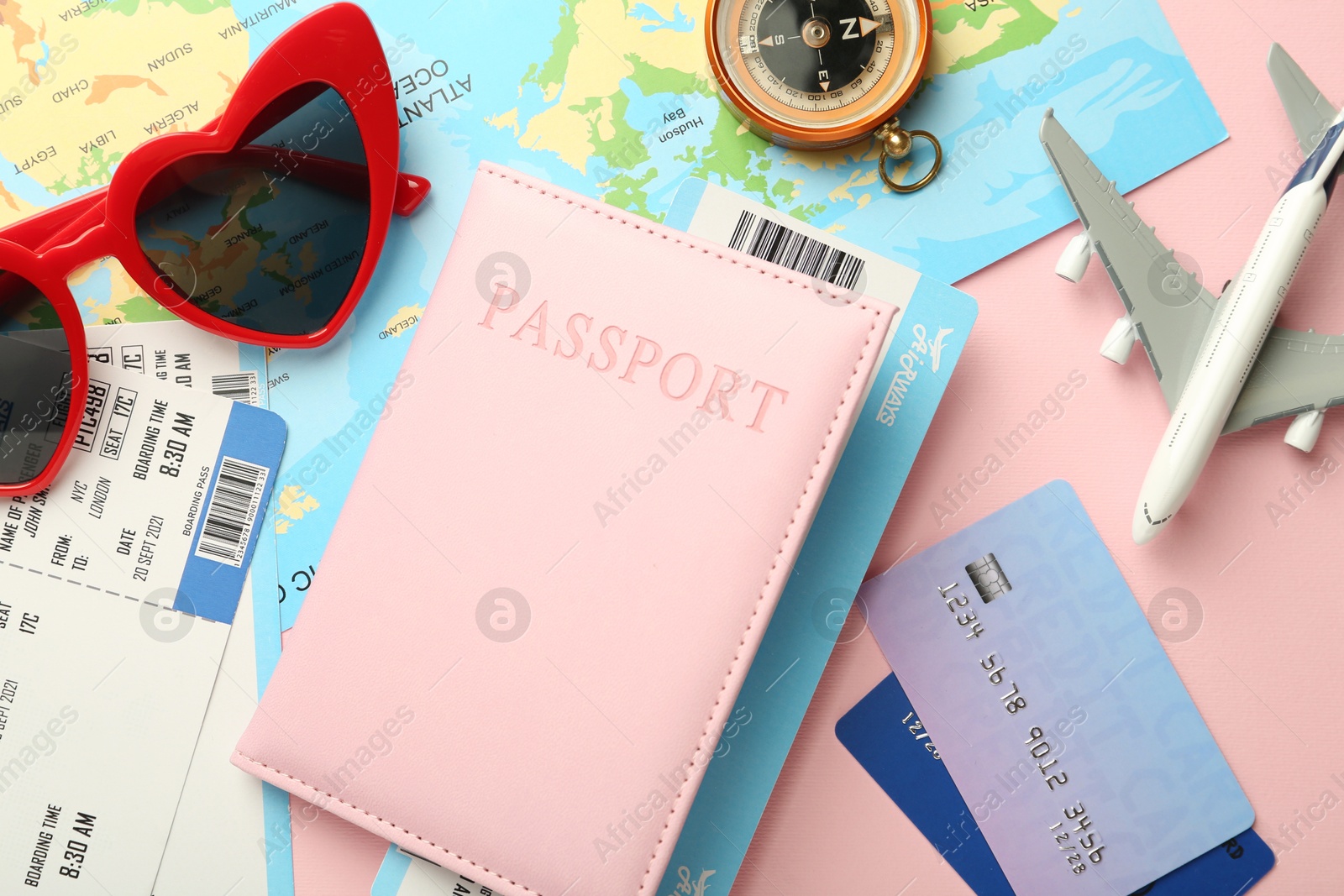 Photo of Flat lay composition with passport and ticket on pink background