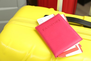 Photo of Passport with tickets on yellow suitcase, closeup