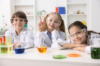 Photo of Children doing chemical experiment at desk indoors