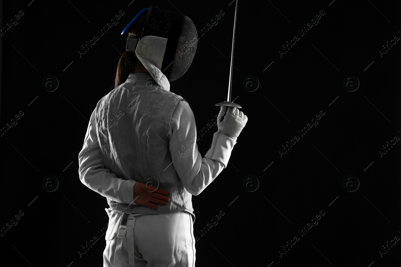 Photo of Fencer with epee on black background, space for text