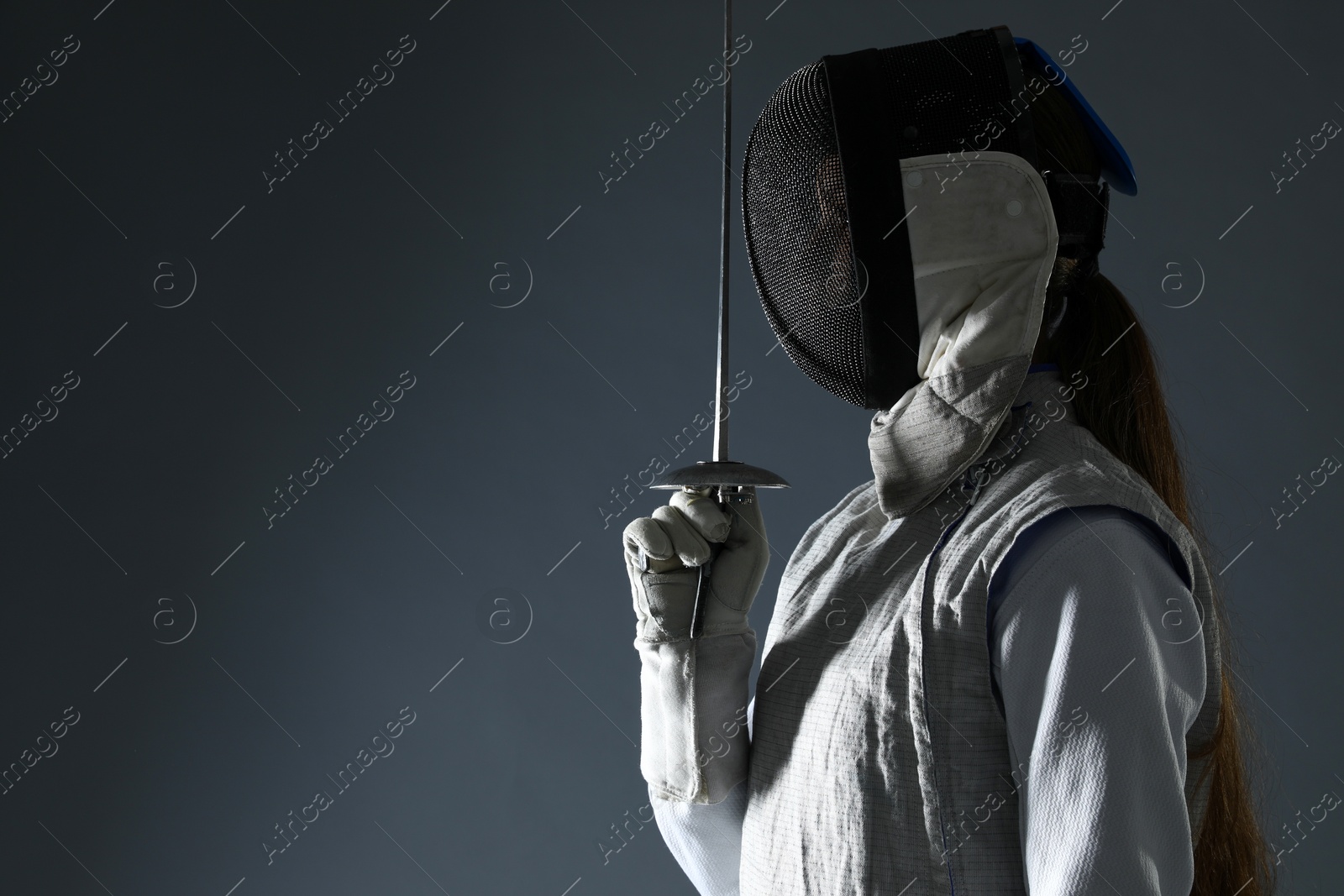 Photo of Fencer with epee on gray background, space for text