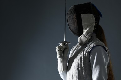 Photo of Fencer with epee on gray background, space for text