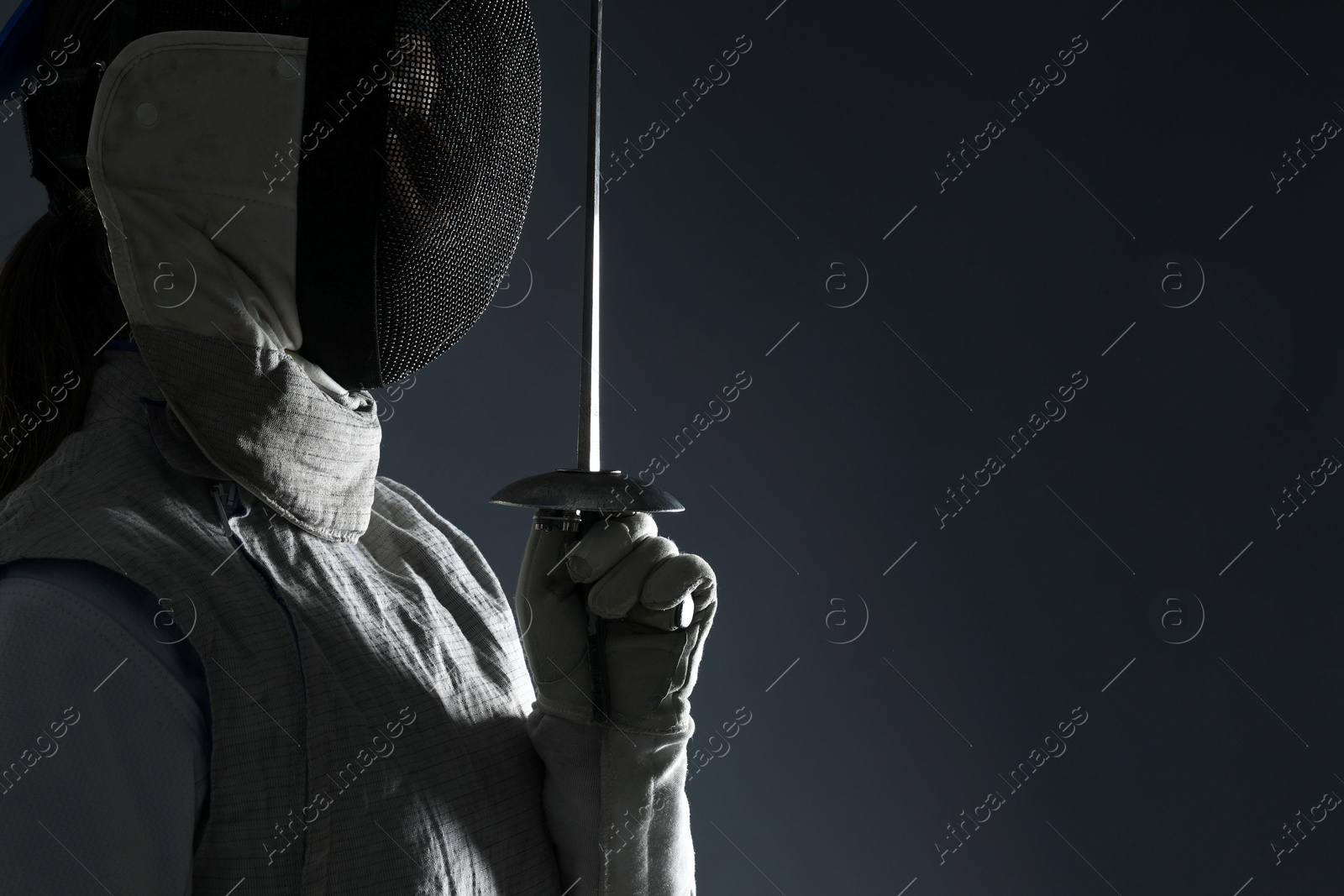 Photo of Fencer with epee on gray background, space for text