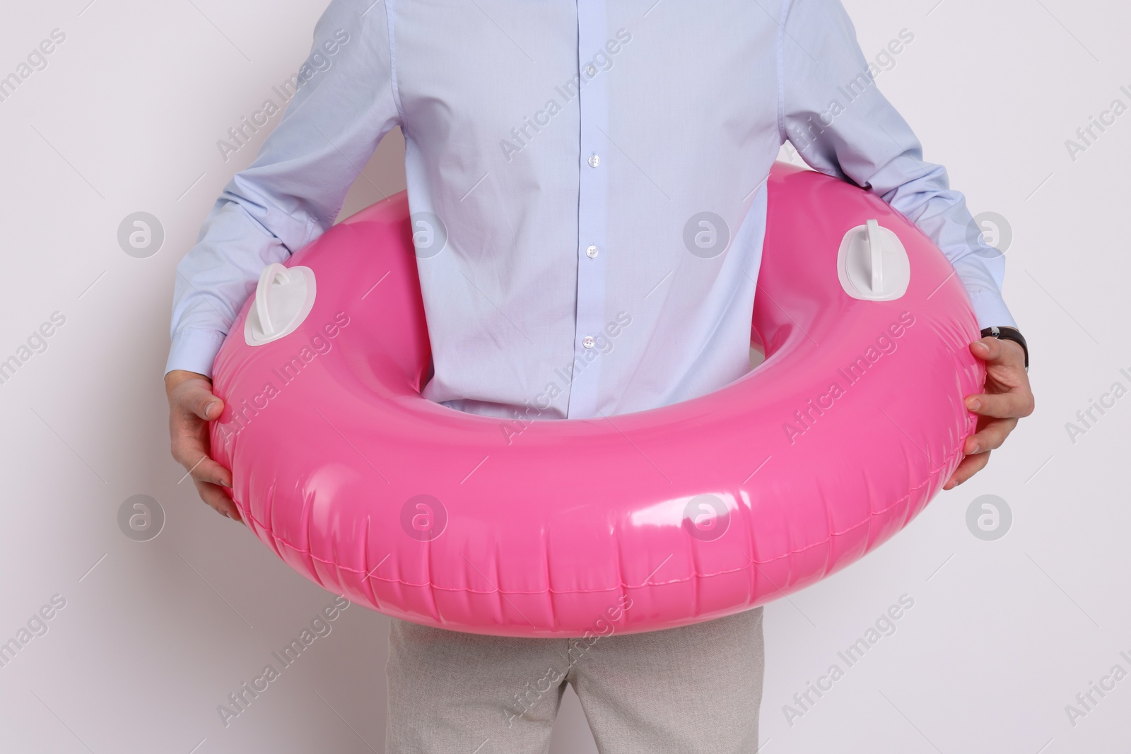 Photo of Businessman with inflatable ring on white background, closeup