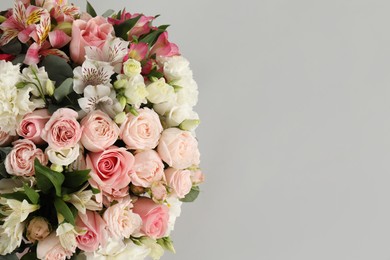 Photo of Bouquet of beautiful flowers on grey background, top view. Space for text