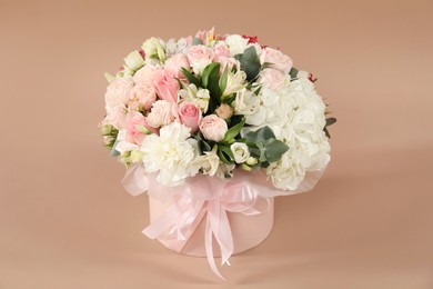 Photo of Bouquet of beautiful flowers on beige background