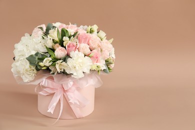 Photo of Bouquet of beautiful flowers on beige background, space for text