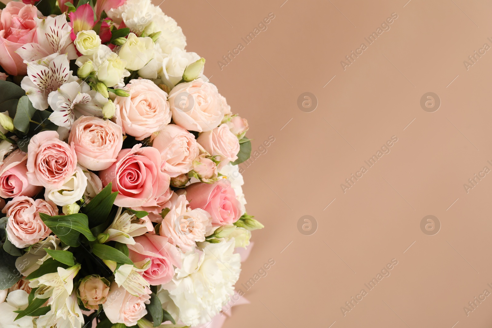 Photo of Bouquet of beautiful flowers on beige background, top view. Space for text