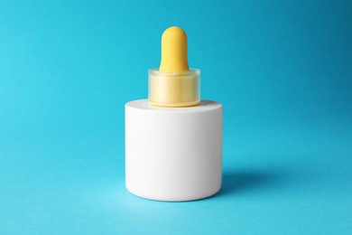 Bottle of skin care product on light blue background