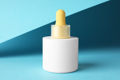 Bottle of skin care product on light blue background