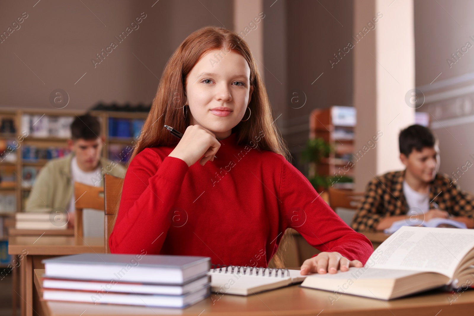 Photo of Girl studying at desk in public library