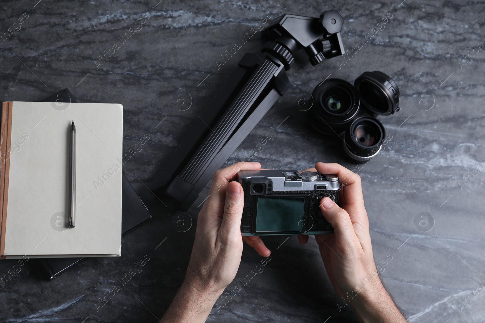 Photo of Photographer with vintage camera at gray marble table, top view