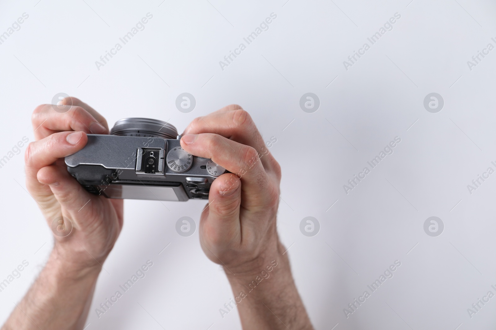 Photo of Photographer with vintage camera on white background, closeup. Space for text