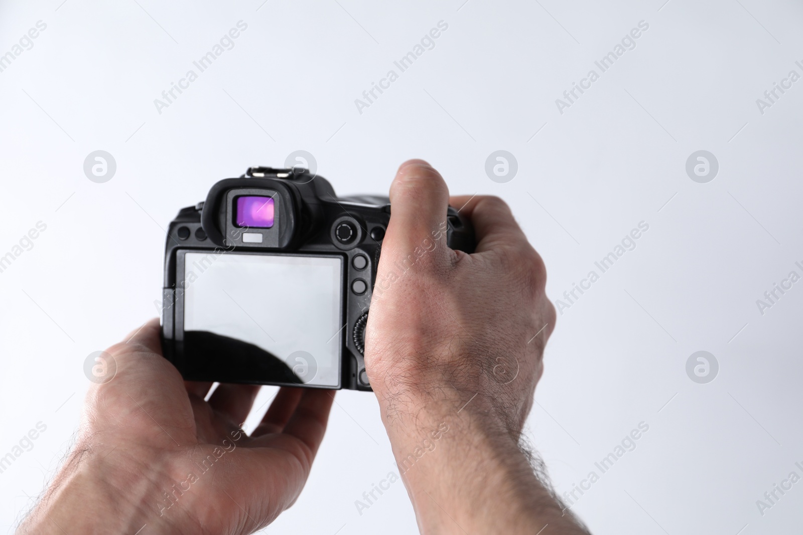 Photo of Photographer with professional camera on white background, closeup. Space for text