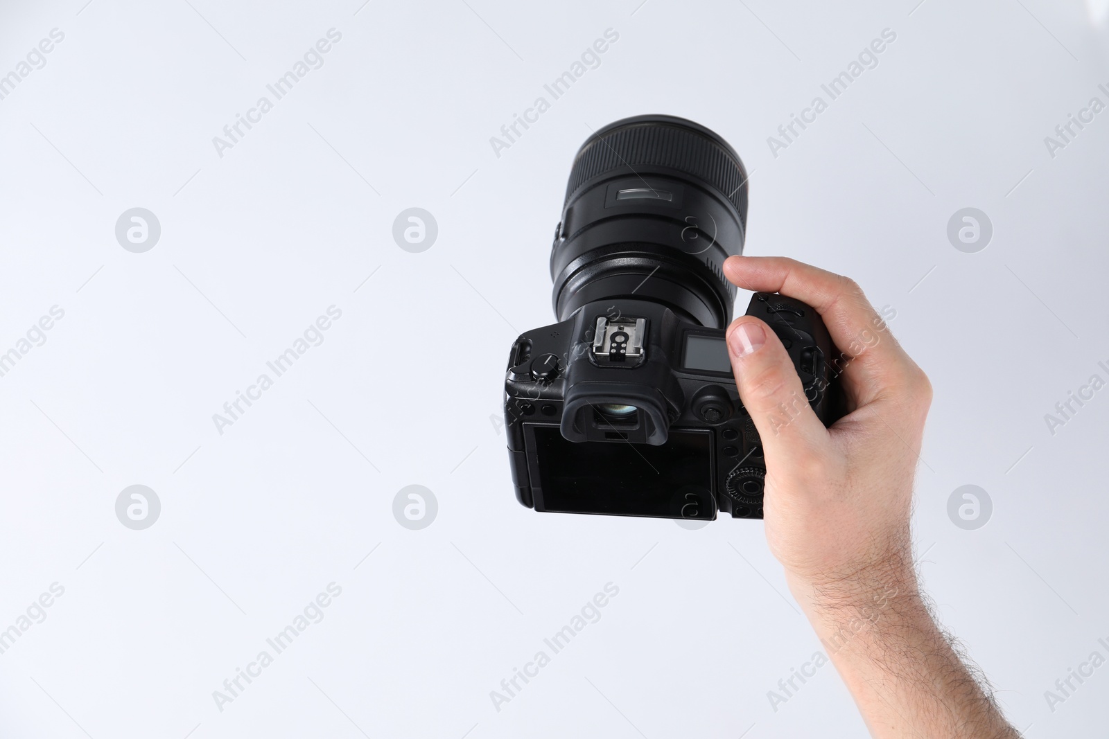 Photo of Photographer with professional camera on white background, closeup. Space for text