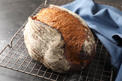 Photo of Freshly baked bread on grey table, closeup