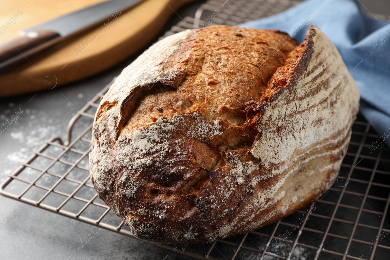 Photo of Freshly baked bread on grey table, closeup