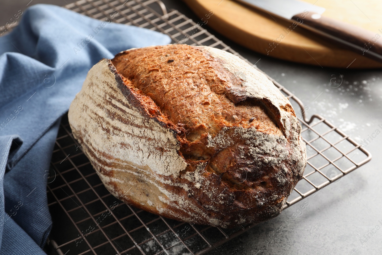 Photo of Freshly baked bread on grey table, closeup