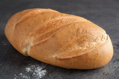 Photo of Freshly baked bread on grey table, closeup