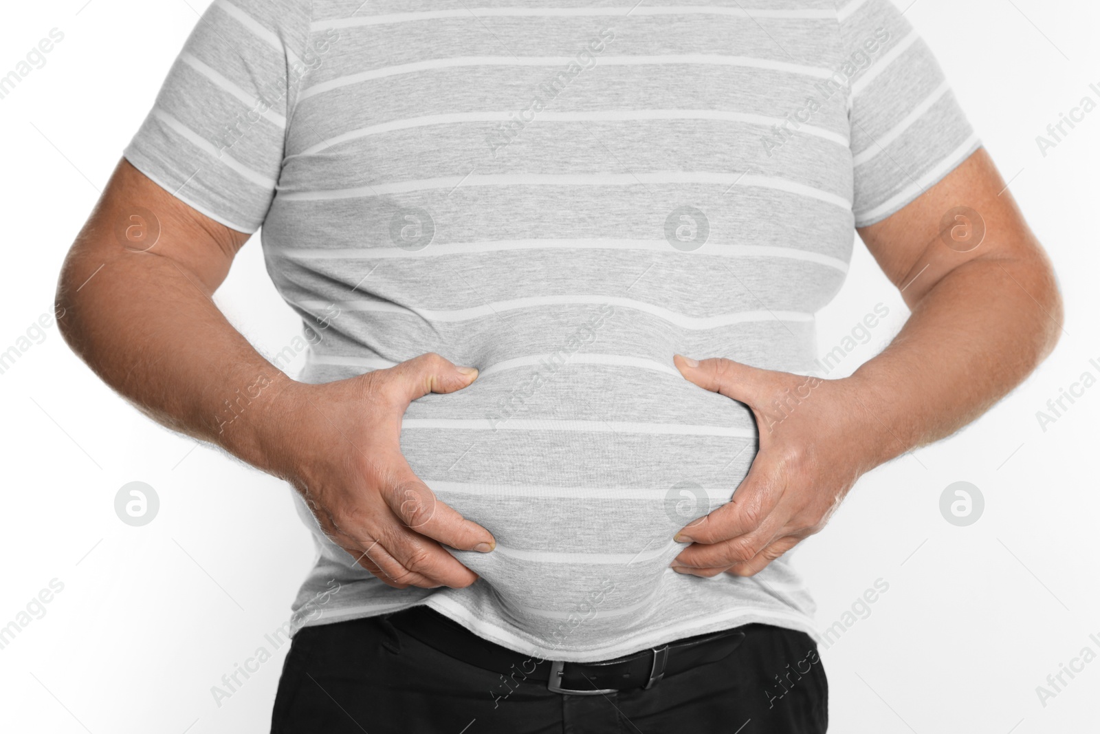 Photo of Overweight man in tight t-shirt on white background, closeup