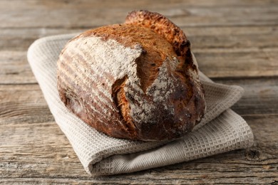 Photo of Freshly baked bread on wooden table, closeup