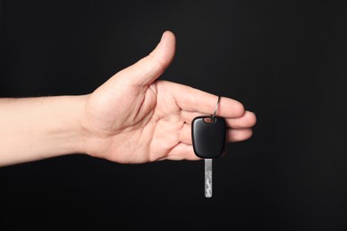 Photo of Man with car key on black background, closeup