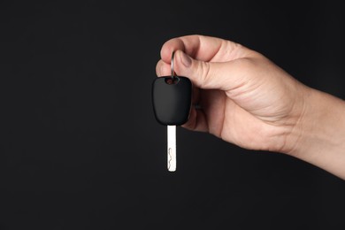 Photo of Man with car key on black background, closeup. Space for text