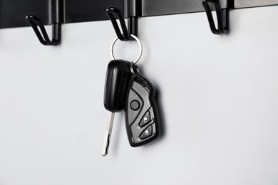 Photo of Car keys on hanger against grey wall