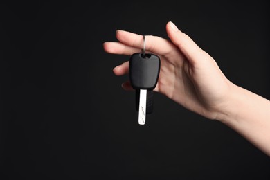 Photo of Woman with car keys on black background, closeup. Space for text