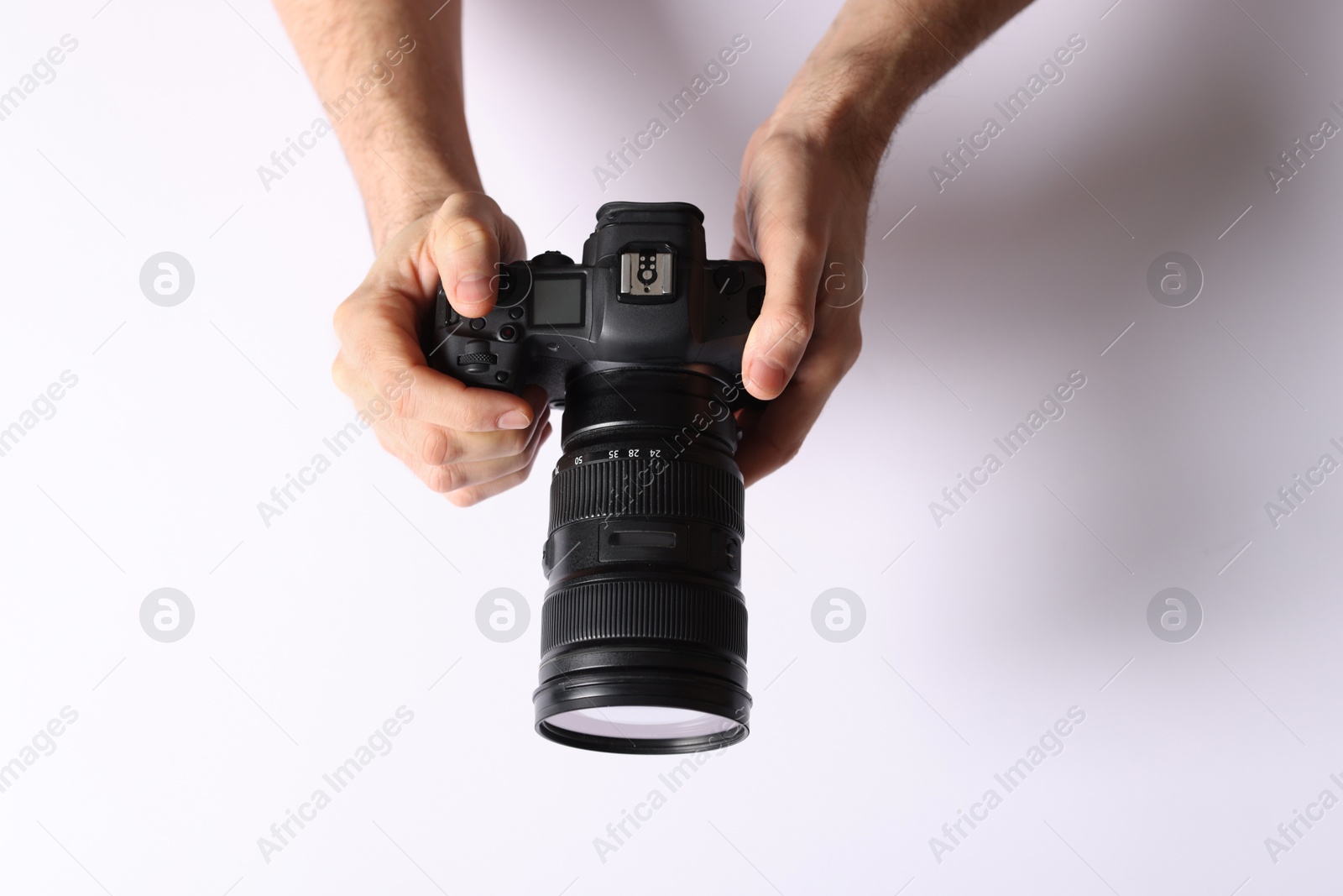 Photo of Photographer with professional camera on light background, above view